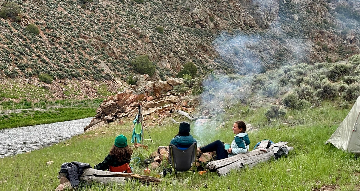 Three people resting after day of backpacking