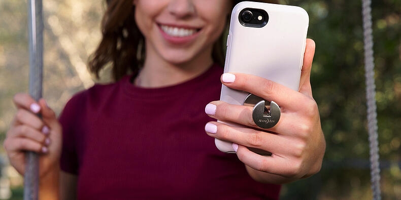 Young woman taking selfie with a FlipOut Phone Handle